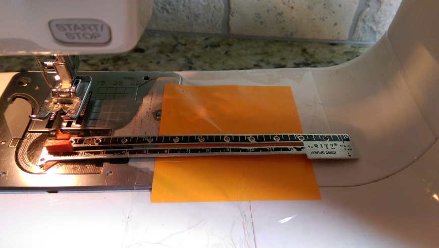 I created a 5-inch hemming guide with a post it note taped to the platform